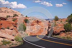 The black asphalt switchbacks surrounded by red rock walls crossing the Capitol Reef National Park