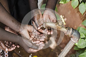 Black Baby Hands Under African Water Tap World Issue