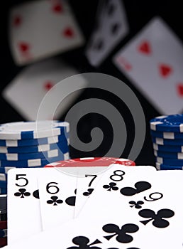 On black background and flying cards, poker chips and winning hand, street