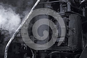 Black background - fragment of a working vintage steam engine