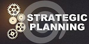 On a black background, gears and the inscription - STRATEGIC PLANNING