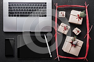 On black background, many gifts and technique. On the tablet screen you can write a message for your loved ones.