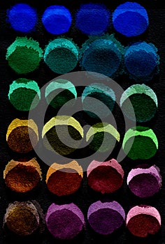 Black background of multicolored watercolor circles. Abstract composition of watercolor circles on a black background.