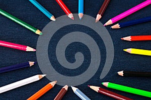 Black background for presentation, copy space in colourful pencils circle