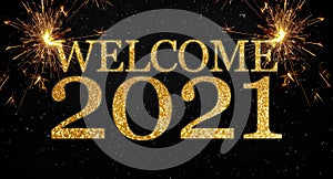 Black background with sparklers and glittery letters showing the words welcome and happy new year 2021