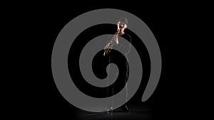 Black background in the studio. Saxophonist playing on the instrument