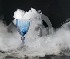 On a black background of transparent glass scattered white smoke.