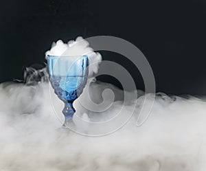 On a black background of transparent glass scattered white smoke.