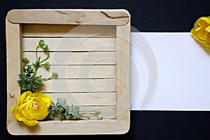 Yellow flower. Yellow rose. Yellow flower with green leaves on a wooden background. Black background.