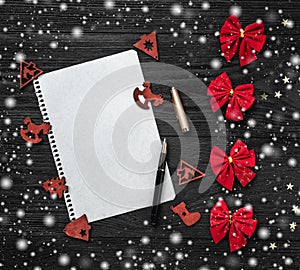 Black background of Xmas. Letter for Santa Claus. Toys and red toys. Space for text. Top view. Snow effect.