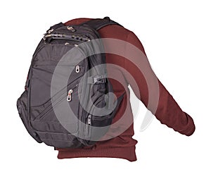 Black backpack dressed in a knitted sweater isolated on a white background