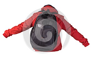 Black backpack dressed in a red jacket isolated on a white background