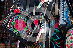 Black bag with colorful embroidery, close-up photo.