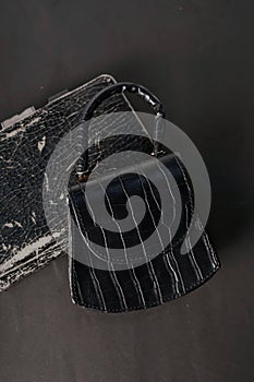 A black bag is placed on a black background.