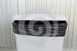 Black bag plastic in white trashcan