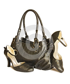 Black bag with shoes isolated on white