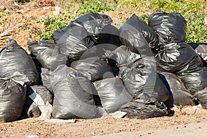 Black bags filled with garbage at roadside