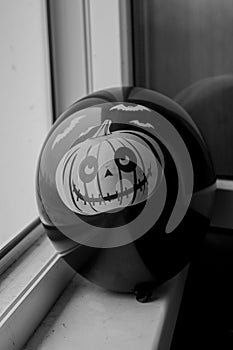 Black balloon with a pumpkin drawnHalloween symbol