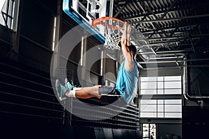 Black basketball player in action in a basketball court.