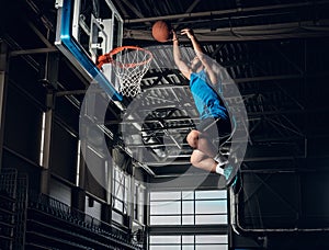 Black basketball player in action in a basketball court.