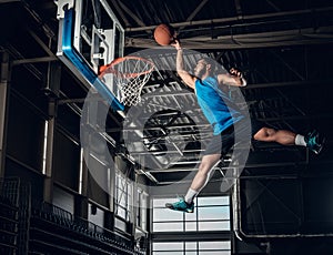 Black basketball player in action in a basketball court.