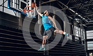 Black basketball player in action in a basketball court.