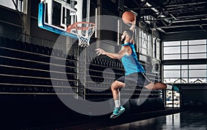 Black basketball player in action in a basketball court.