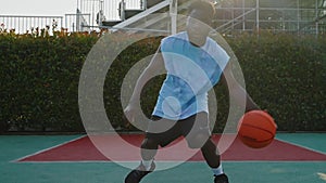 Black basketball player performing dribbling and ball handling drills