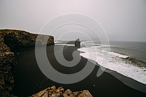 Black beach Kirkjufjara during the storm on Atlantic ocean.