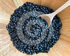 Top view of Black bean in wooden blow, properties help to detoxify and nourish the kidneys well. Due to the presence of flavonoids photo