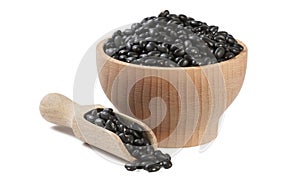 Black bean in wooden bowl and scoop isolated on white background. nutrition. food ingredient