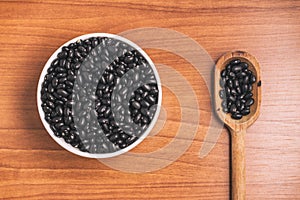 Black beans into a bowl and spoon. Phaseolus vulgaris 'Black tur