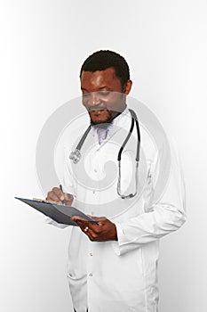 Black bearded doctor man in white coat with stethoscope filling medical records on clipboard