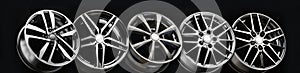 black beautiful sports alloy wheels forged stand in a row on a black background