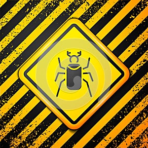 Black Beetle bug icon isolated on yellow background. Warning sign. Vector