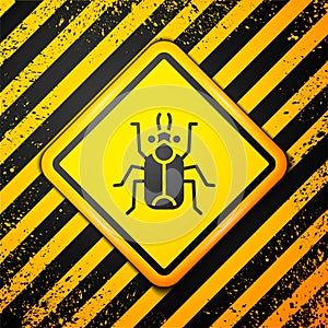 Black Beetle bug icon isolated on yellow background. Warning sign. Vector