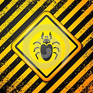 Black Beetle deer icon isolated on yellow background. Horned beetle. Big insect. Warning sign. Vector