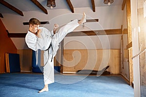 Black belt karate fighter training hight kick