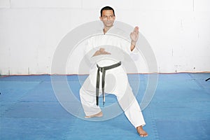Black belt karate man with hand in spade position