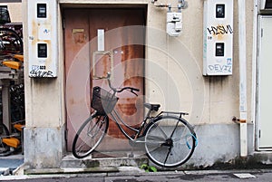 Black bicycle park in front of an old rustic door