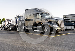 Black big rig powerful semi truck transporting coupled another semi tractors photo