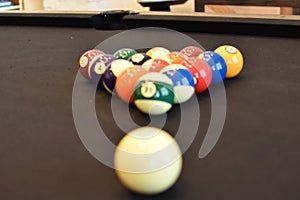 Black billiard table, Playing snooker pool 8ball - Close-up shot of a man playing billiard