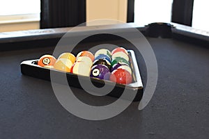 Black billiard table, Playing snooker pool 8ball - Close-up shot of a man playing billiard
