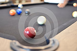 Black billiard table, Playing snooker pool 8ball - Close-up shot of a man playing billiard photo