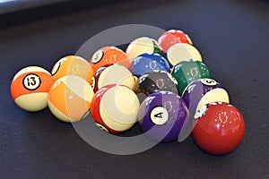 Black billiard table, Playing snooker pool 8ball - Close-up shot of a man playing billiard photo
