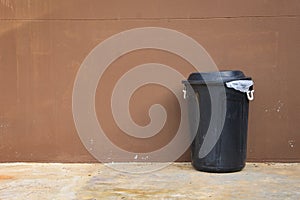 Black bin and wall on road