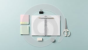 A black binder clip a gray circular eraser and a white rectangular