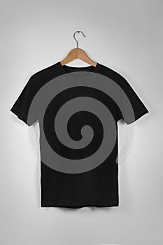 Black Blank Cotton Tshirt Hanging Center Gray Concrete Empty Wall Background with clipping path