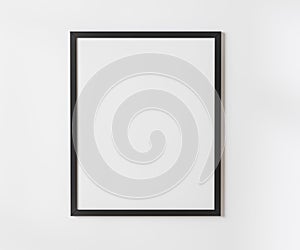 Black blank frame on white wall mockup, 4:5 ratio - 40x50 cm, 16 x 20 inches, poster frame mockup, 3d rendering.