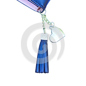Black or blue leather keychain in square steel with heart patterns hanging on women`s purse isolated on white background with clip